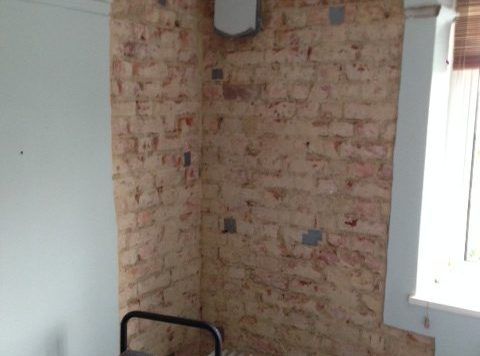 Wall being dried by dehumidifier