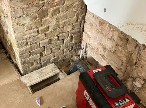 Dehumidifier drying a wall in London