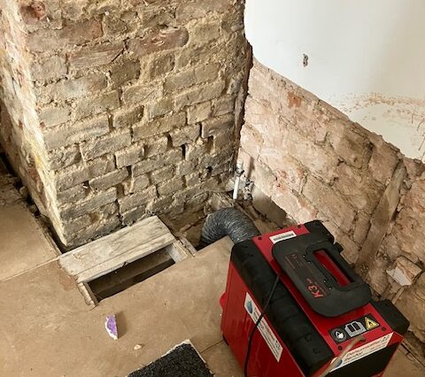 Dehumidifier drying a wall in London